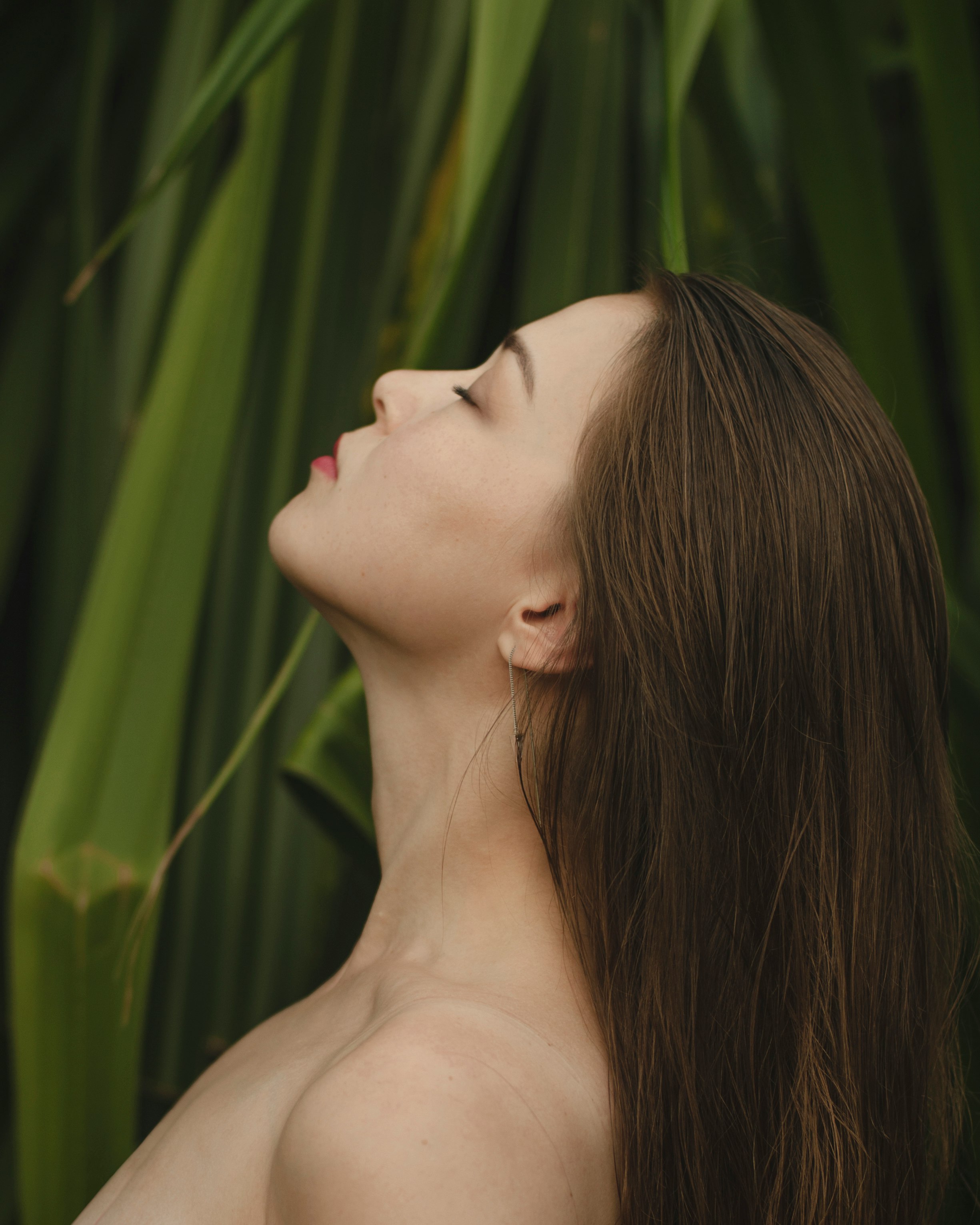 woman on front of green leaves